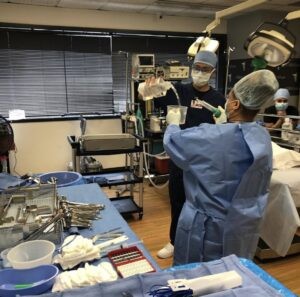 Image of surgeons performing a surgical procedure in an operating room.