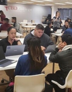 A group of CBD College students taking an exam on computers inside a laboratory.
