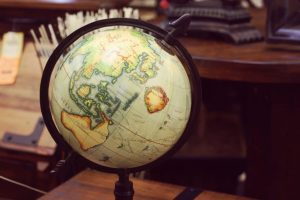 A globe resting on a wooden desk, symbolizing global awareness, education, and exploration.