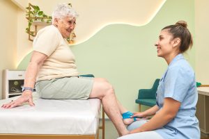A physical therapist assistant, working with a patient, assisting in exercises or therapy sessions.