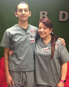 Steven Hernandez and Elizabeth Rangel, Diagnostic Medical Sonography students at CBD College, pose together in front of a sonography machine, showcasing their dedication to their studies and passion for healthcare.